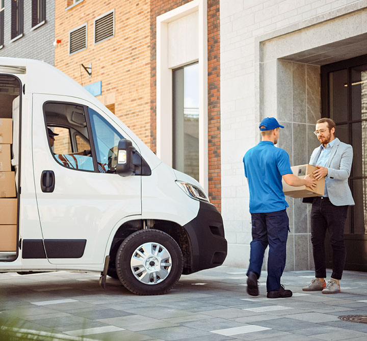 Delivery driver handing a package to a customer