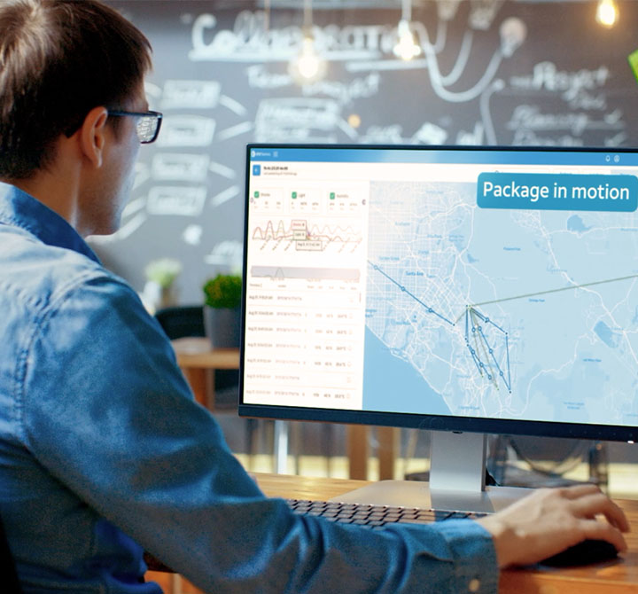 Professional sitting at a desk viewing location data on a monitor