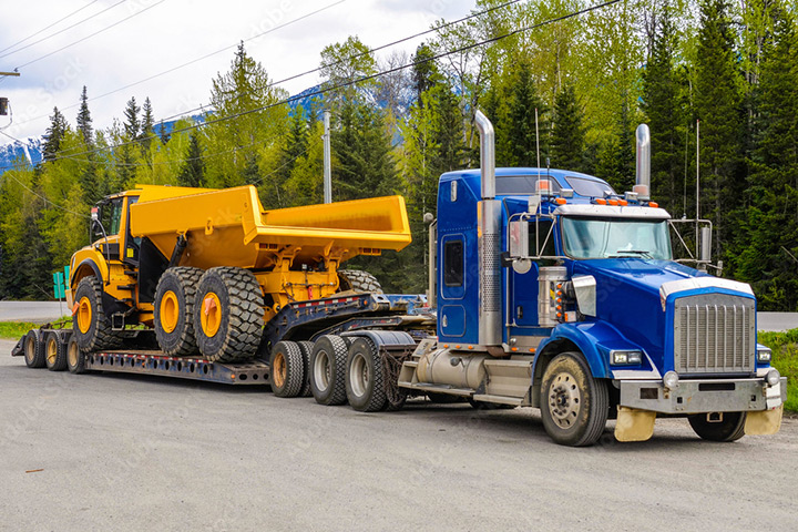 Semi truck hauling large equipment machinery