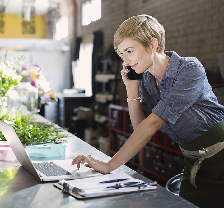 Small business woman on laptop and phone