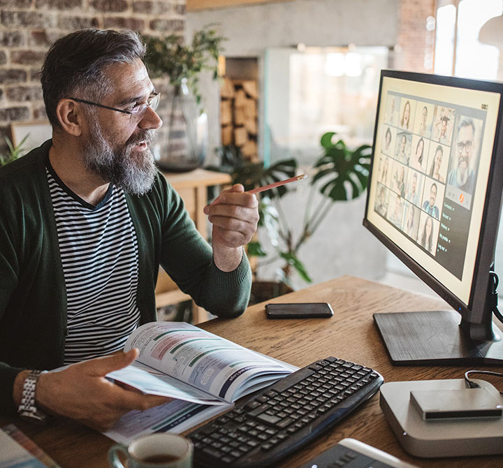 A woman is video conferencing from her computer using reliable, robust AT&T Business Fiber and Switched Ethernet on Demand.